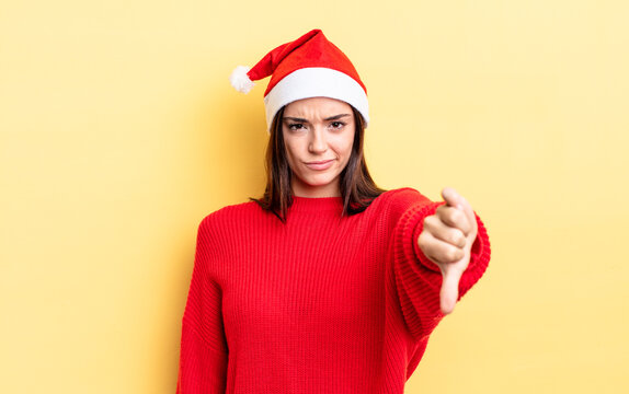 young hispanic woman feeling cross,showing thumbs down. chistmas and new year concept