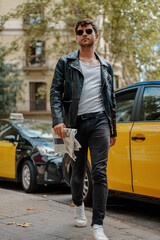 Portrait of sexy man near taxi station
