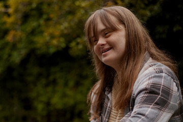 Portrait of young woman with Down Syndrome looking confident outdoors