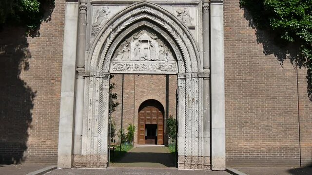 Ravenna Italy JUNE, 5, 2016 Crossing by walking in the arched entrance portal of the Franciscan monastery of Ravenna. Basilica of San Francesco