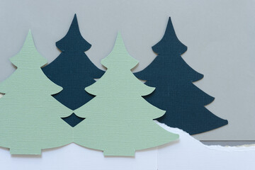 green and blue paper christmas trees in a paper landscape