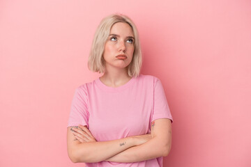 Fototapeta premium Young caucasian woman isolated on pink background tired of a repetitive task.
