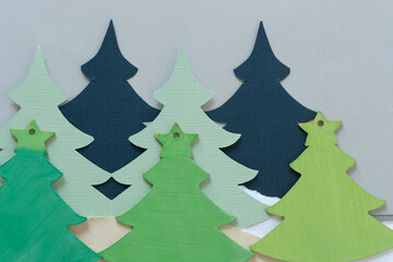 crafting green christmas trees made of paper and wood