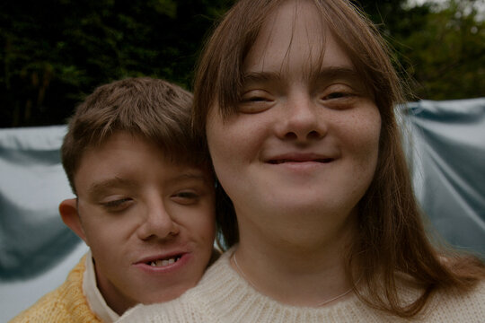 Young couple with Down Syndrome and Foetal Alcohol Syndrome looking content and happy