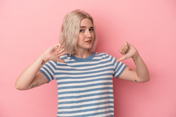 Young caucasian woman isolated on pink background showing thumb down, disappointment concept.
