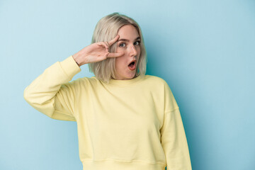 Young caucasian woman isolated on blue background dancing and having fun.