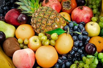 Various assorted juicy fruits. Fresh fruits colorful background.