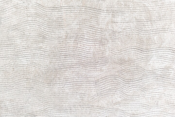 Rustic rough cement wall, with lines made with a notched trowel