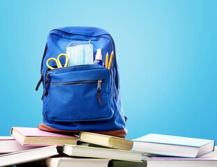 Stylish backpack and different school stationery on desk. Back to school