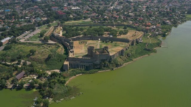 Belgorod-Dnestrovskaya fortress from a bird's eye view. The largest fortress in Ukraine is located on the Dniester River. Green blooming water and white-stone walls of the fortress.