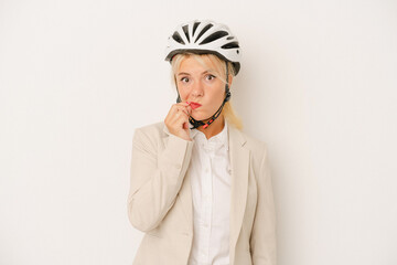 Young business Russian woman holding bike helmet isolated on white background with fingers on lips keeping a secret.