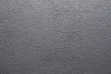 Grey matte stone wall texture. Uneven surface painted in gray colour. Backdrop with irregularities...