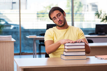 Young male student preparing for exams in the classroom