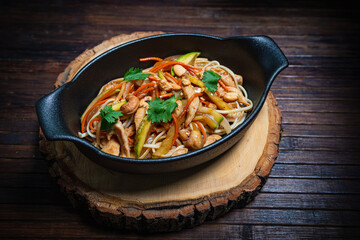 Asian style- restaurant background. Udon noodles with beef Wok