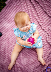 little girl with toys in the forest