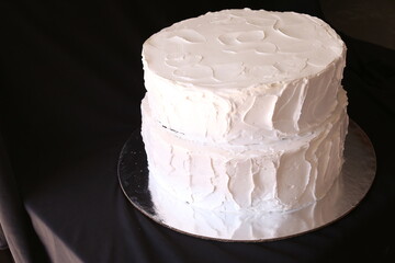 White cake, Sweet cake with floral decor on table against color background