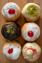 Doughnuts with different types of fillings close up photo. Authentic Israeli doughnut - sufgania. Symbols of Hanukkah fest.