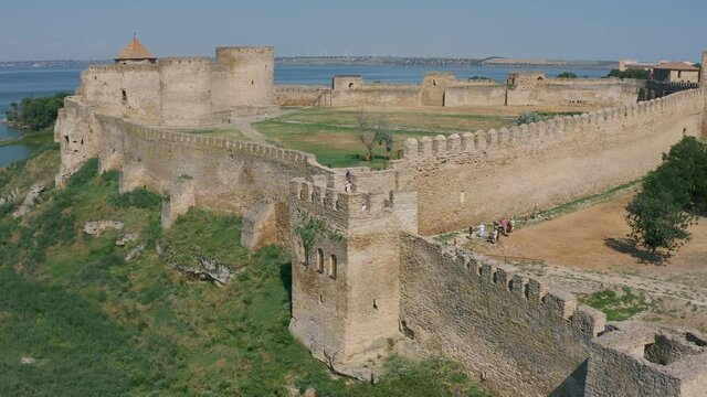 Belgorod-Dnestrovskaya fortress from a bird's eye view. The largest fortress in Ukraine is located on the Dniester River. Green blooming water and white-stone walls of the fortress.