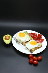 Vegetarian toast with egg and avocado, toast bread, black background