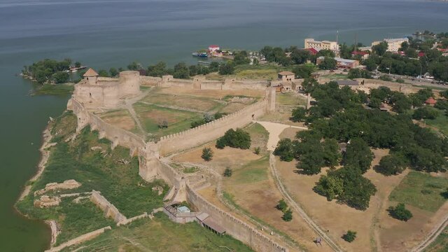 Belgorod-Dnestrovskaya fortress from a bird's eye view. The largest fortress in Ukraine is located on the Dniester River. Green blooming water and white-stone walls of the fortress.