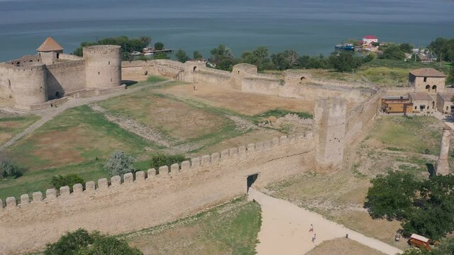 Belgorod-Dnestrovskaya fortress from a bird's eye view. The largest fortress in Ukraine is located on the Dniester River. Green blooming water and white-stone walls of the fortress.