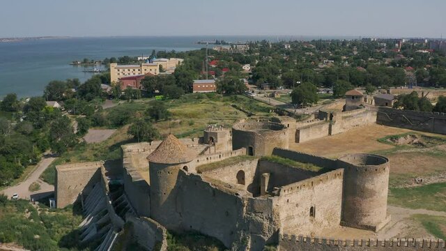 Belgorod-Dnestrovskaya fortress from a bird's eye view. The largest fortress in Ukraine is located on the Dniester River. Green blooming water and white-stone walls of the fortress.