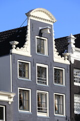 Fototapeta na wymiar Amsterdam Traditional Canal House Facade Detail with Sculpted Neck Gable, Holland