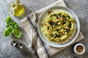 Vegan green risotto with zucchini cream and walnuts