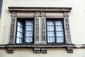 Fototapeta na wymiar Two windows of an old classic building