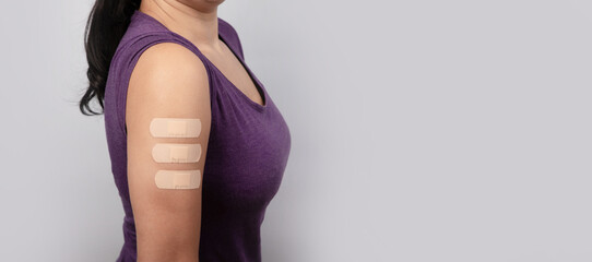 woman showing many medical patch on arm after vaccine, coronavirus immunization, health care...