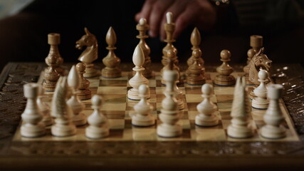 Old man hands playing chess closeup. Unknown professional player