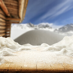 Wooden desk cover of snow and winter time in mountains. 
