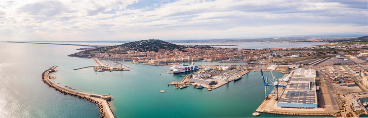 Naklejka na ściany i meble Aerial panorama of the port of Sète at sunset in Hérault in Occitanie, France