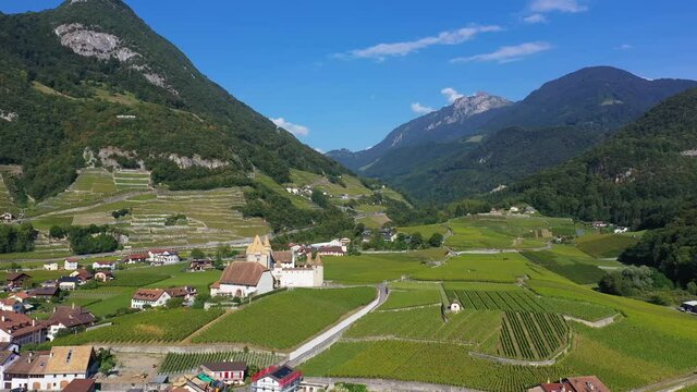 Aerial drone footage of the Aigle castle in the middle of vineyards in Canton Vaud in Switzerland