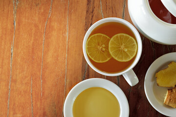 Obraz na płótnie Canvas Hot tea with lemon,honey and ginger on wooden background