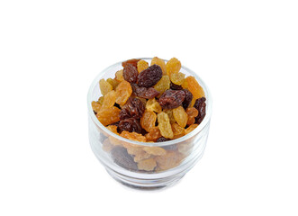 Dried raisins in glass on white background