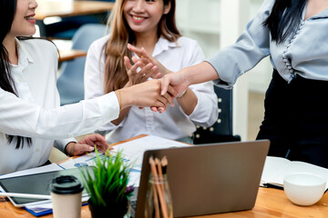 Close-up of business people shaking hands at the office success cooperation agreement.