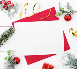 Christmas card with place to insert text and Christmas decorations. New Year's decor of fir branches, balls and ribbons. Holiday concept. Mockup