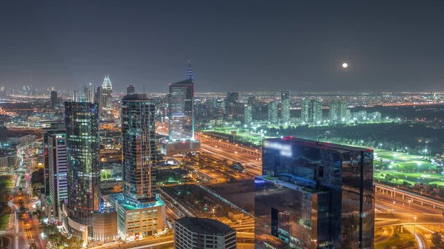 Moon rising over media city and al barsha heights district area night timelapse from Dubai marina.