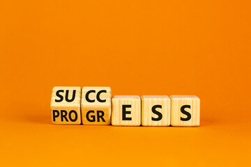 Success business progress symbol. Turned wooden cubes with words 'success progress'. Beautiful orange background, copy space. Success business progress concept.