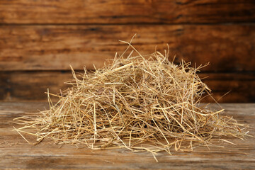Heap of dried hay on wooden table © New Africa