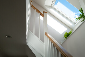 Abstract view of a newly installed loft conversion seen from the ground floor, looking at the...