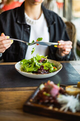 woman eating salad in the restaurant