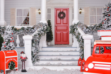 Fototapeta premium Christmas courtyard with Christmas porch, veranda, wreath, Christmas tree, red car, gnome, letterbox for Santa Claus, lanterns, garland. Merry Christmas and Happy New Year