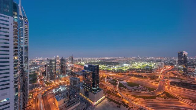 Aerial view of media city and al barsha heights district area day to night timelapse from Dubai marina.