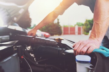 mechanic inspects the expansion tank with antifreeze. Ð¡ar's radiator system.