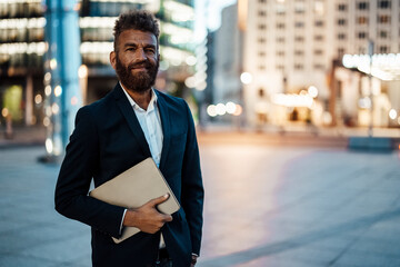 Smiling male freelance worker with beard holding digital tablet