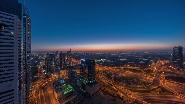 Aerial view of media city and al barsha heights district area night to day timelapse from Dubai marina.