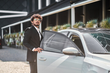 Indian businessman opens car door