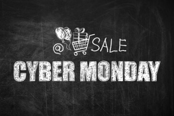 Text Cyber Monday Sale and picture of shopping cart on blackboard